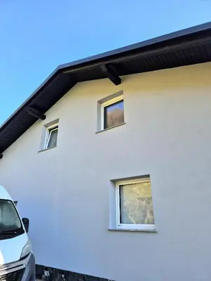 a white house with three windows on it at Apartment Doroteja in Podplat