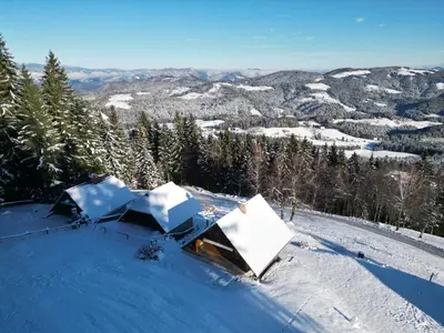 a couple of tents on top of a snow covered slope at Private Forest Cabin with Epic View in Ribnica na Pohorju