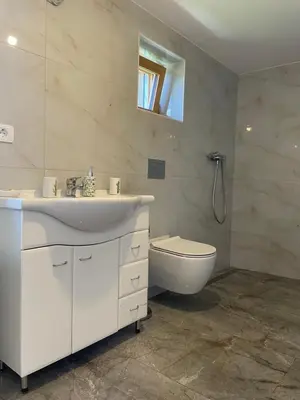 a white bathroom with a sink and a toilet at Zerko Holiday Apartment MARJETKA with WELLNESS bookable separately in Mirna