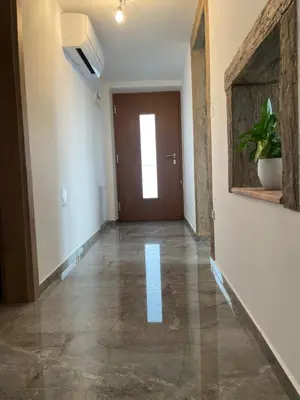 an empty hallway with a brown door and a hallwayngth at Zerko Holiday Apartment MARJETKA with WELLNESS bookable separately in Mirna