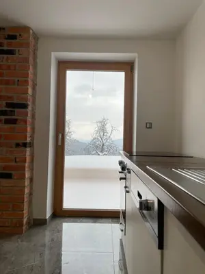 a kitchen with a large window with a view at Zerko Holiday Apartment MARJETKA with WELLNESS bookable separately in Mirna