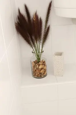 a vase with a plant in it on a shelf at EMIA Family House Čatež in Brežice