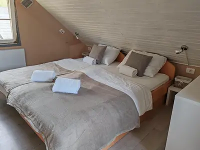 a bedroom with two beds with towels on them at EMIA Family House Čatež in Brežice