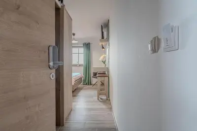 a hallway with a door to a room with a bedroom at Lukec Estate in Kostel