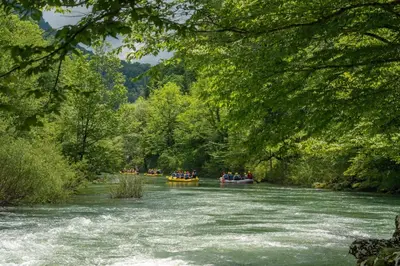 a group of people in boats on a river at Lukec Estate in Kostel