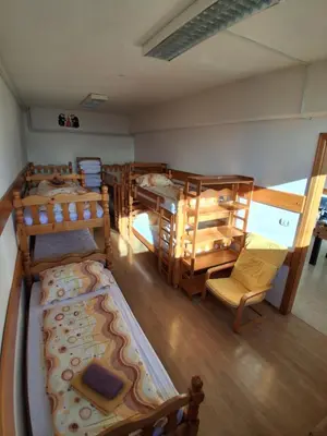 an overhead view of a room with many bunk beds at Tau Forest Lodge in Solkan