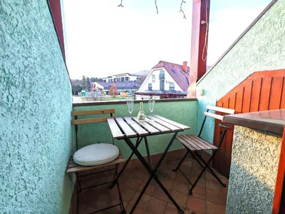 a small table and chairs on a balcony at Apartma Roglina in Zreče