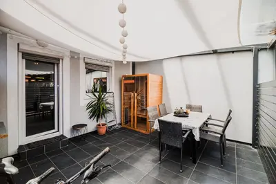 a dining room with a table and chairs on a patio at Holiday Home Tinkara with IR Sauna in Čatež ob Savi