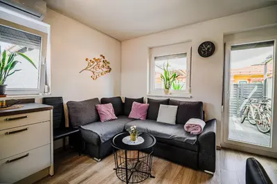 a living room with a couch and a table at Holiday Home Tinkara with IR Sauna in Čatež ob Savi