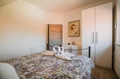 a bedroom with a bed with two towels on it at Holiday Home Tinkara with IR Sauna in Čatež ob Savi