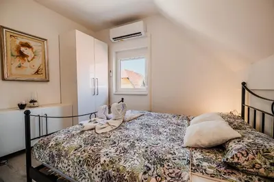 a bedroom with a bed with a stuffed animal on it at Holiday Home Tinkara with IR Sauna in Čatež ob Savi