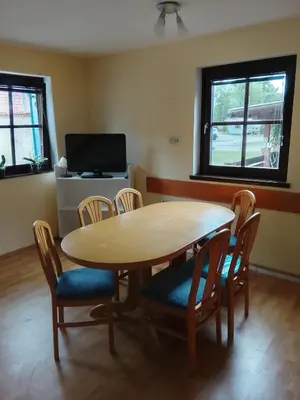 a dining room with a wooden table and chairs at Julijana's Holiday Home in Brežice