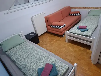 a living room with two beds and a couch at Aca's & Lidija's Thermal Hideaway Čatež-Tickets included-min 2 nights in Brežice