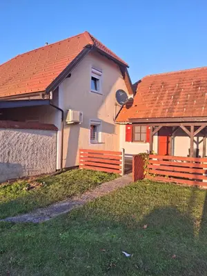 a house with an orange roof and a fence at Aca's & Lidija's Thermal Hideaway Čatež-Tickets included-min 2 nights in Brežice