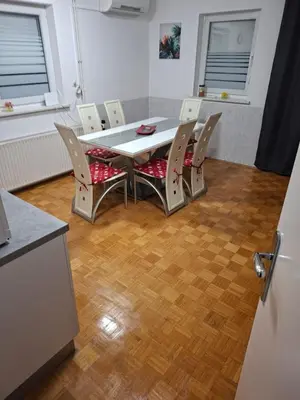a table and chairs in a room with a kitchen at Aca's & Lidija's Thermal Hideaway Čatež-Tickets included-min 2 nights in Brežice