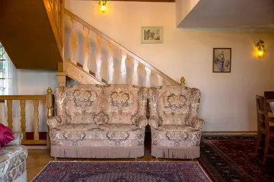 a couch sitting in a living room with a staircase at Holiday Home with BBQ in Novo mesto 54727 in Novo Mesto