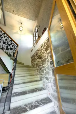 a staircase in a house with a stone wall at Holiday Home with BBQ in Novo mesto 54727 in Novo Mesto