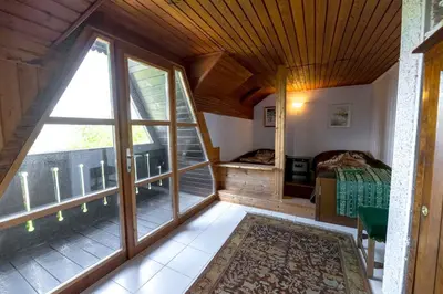 a bedroom with a bed and a large window at Holiday Home with BBQ in Novo mesto 54727 in Novo Mesto