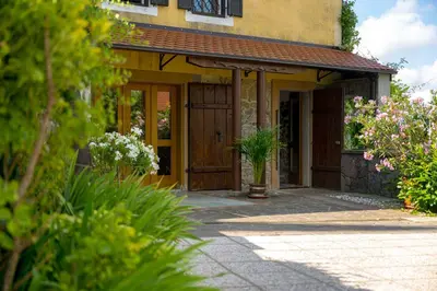 a front door of a house with flowers at Holiday Home with BBQ in Novo mesto 54727 in Novo Mesto