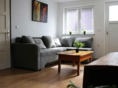 a living room with a couch and a table at Holiday Home with A - C in Zgornji Leskovec 54833 in Zgornji Leskovec