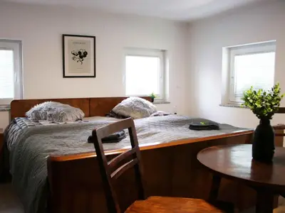 a bedroom with two beds and a table and a table sidx sidx sidx at Holiday Home with A - C in Zgornji Leskovec 54833 in Zgornji Leskovec