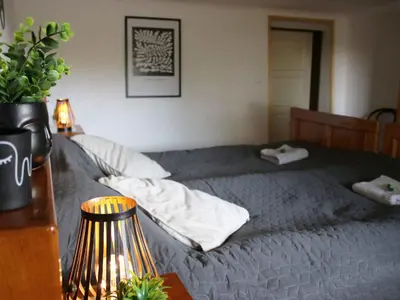 a bedroom with a bed and a table with a lamp at Holiday Home with A - C in Zgornji Leskovec 54833 in Zgornji Leskovec