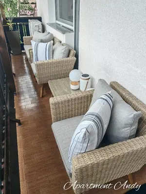 a living room with wicker chairs and pillows at Apartment Andy in Medvode