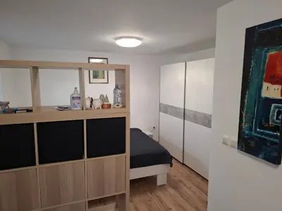a bedroom with a bed and a dresser at Apartma Dividenda in Ptuj