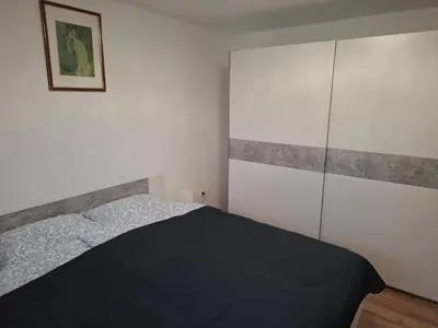 a small bedroom with a bed and a closet at Apartma Dividenda in Ptuj