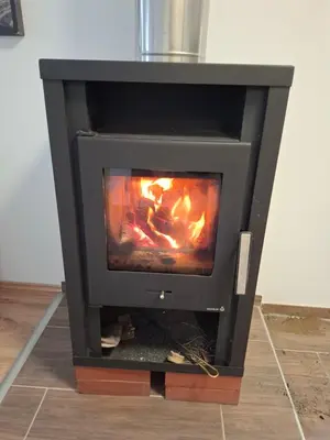 a stove with a fire inside of it at Apartma Dividenda in Ptuj