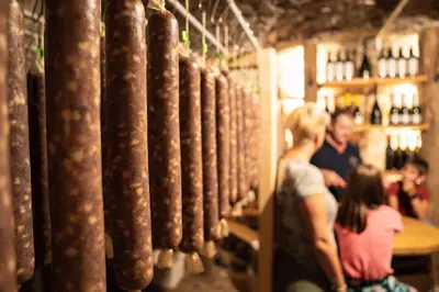 a group of people standing in a wine cellar at Holiday Home Pr'Lukčevih with 4 Bedrooms & Indoor Sauna in Kanal