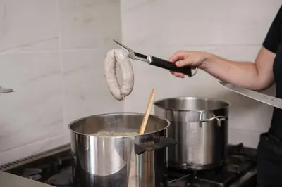 a person cooking food in a pot on a stove at Holiday Home Pr'Lukčevih with 4 Bedrooms & Indoor Sauna in Kanal