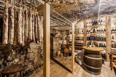 a wine tasting room with sausages on the wall at Holiday Home Pr'Lukčevih with 4 Bedrooms & Indoor Sauna in Kanal