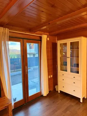 a room with sliding glass doors and a cabinet at Wooden Cabin in Ljubljana in Ljubljana