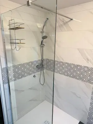 a shower with a glass door in a bathroom at Wooden Cabin in Ljubljana in Ljubljana