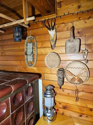a room with wooden walls with various items on the wall at Hiška Polhec in Bovec