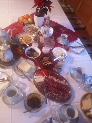 a table with many plates of food on it at Tourist Farm Arbajter in Resnik