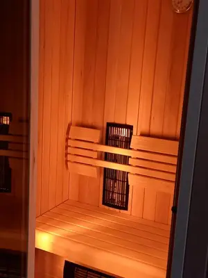 a sauna with wood paneled walls and wooden shelves at Tourist Farm Arbajter in Resnik