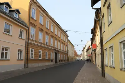 an empty street in a city with buildings at AMS Rooms in Ljubljana
