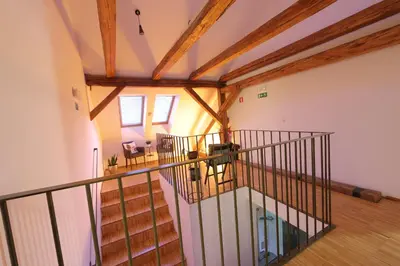 an overhead view of a staircase in a room with wooden ceilings at AMS Rooms in Ljubljana