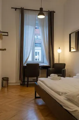 a bedroom with a bed and a large window at AMS Rooms in Ljubljana