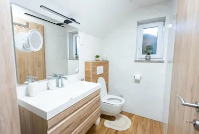 a bathroom with a white sink and a toilet at Apartment Angelina in Metlika