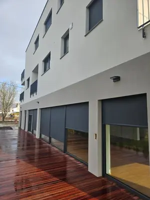 a building with large windows and a wooden floor at APARTMENTS MURIC LJubljana in Ljubljana