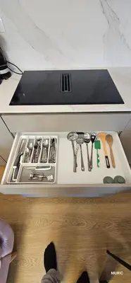 a drawer with utensils on a shelf in a kitchen at APARTMENTS MURIC LJubljana in Ljubljana