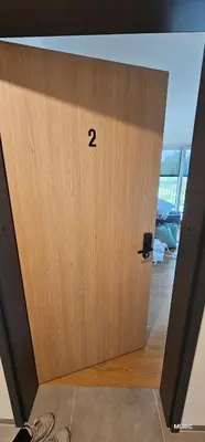 a wooden door with the number on it at APARTMENTS MURIC LJubljana in Ljubljana