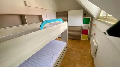 a room with two bunk beds and a staircase at Villa Petz in Brežice
