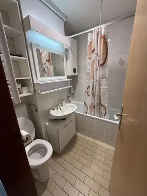 a bathroom with a toilet and a sink at MATT Cozy Stay in Bovec