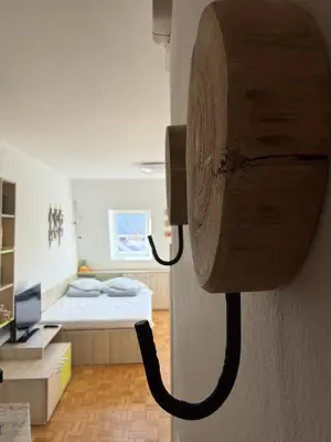 a room with a bed and a phone on the wall at MATT Cozy Stay in Bovec