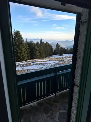 a view from a window of a snow covered mountain at Apartma Ajdovka Rogla in Rakovec