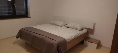 a small bedroom with a bed with two pillows at apartma Kiana in Šempeter pri Gorici